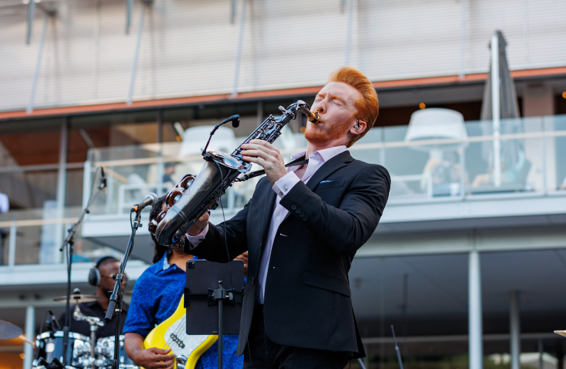 A musician playing the saxophone at City Center Bishop Ranch